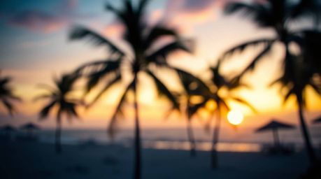 Capture the serene beauty of a tropical beach sunset with a blurred bokeh effect, emphasizing cool colors like blues, greens,