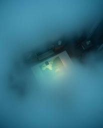 An overhead bird's-eye view photograph captures the eerie beauty of an old study shrouded in thick fog. A glowing map project