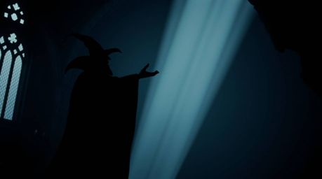 A silhouetted figure in a strong, moody style with low contrast depicts a classic Disney villain casting a spell within the c
