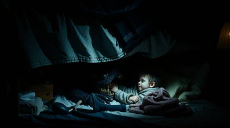A captivating cinematic still life image depicts an unlikely friendship between a child and a monster hiding under the bed.  