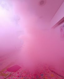 A room filled with a chaotic yet captivating explosion of paint, heavily obscured by thick fog, significantly reducing visibi