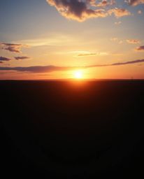 A breathtaking cinematic-style film still captures a dramatic sunrise over a war-torn landscape.  The image showcases stunnin