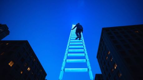 Explore the captivating world of bioluminescent street photography featuring a businessperson ascending a transparent ladder 
