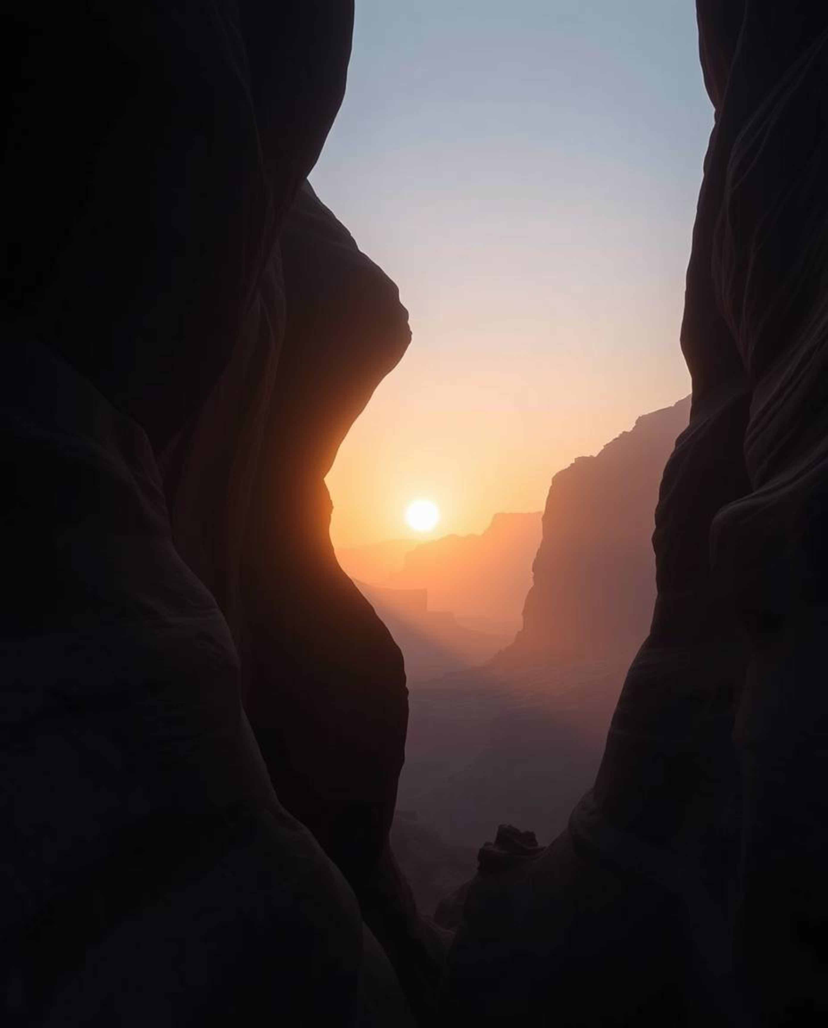 A dreamy photograph with a distinct split composition depicts a hazy sunset illuminating sandstone cliffs in a canyon. The im
