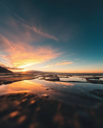 This is a geometric logo design inspired by a sunset sky mirrored in tidal pools, viewed from a striking low-angle perspectiv