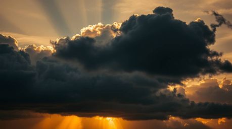 This dramatic image captures the tension created by intense sunset lighting illuminating thunderstorm clouds. The high-contra