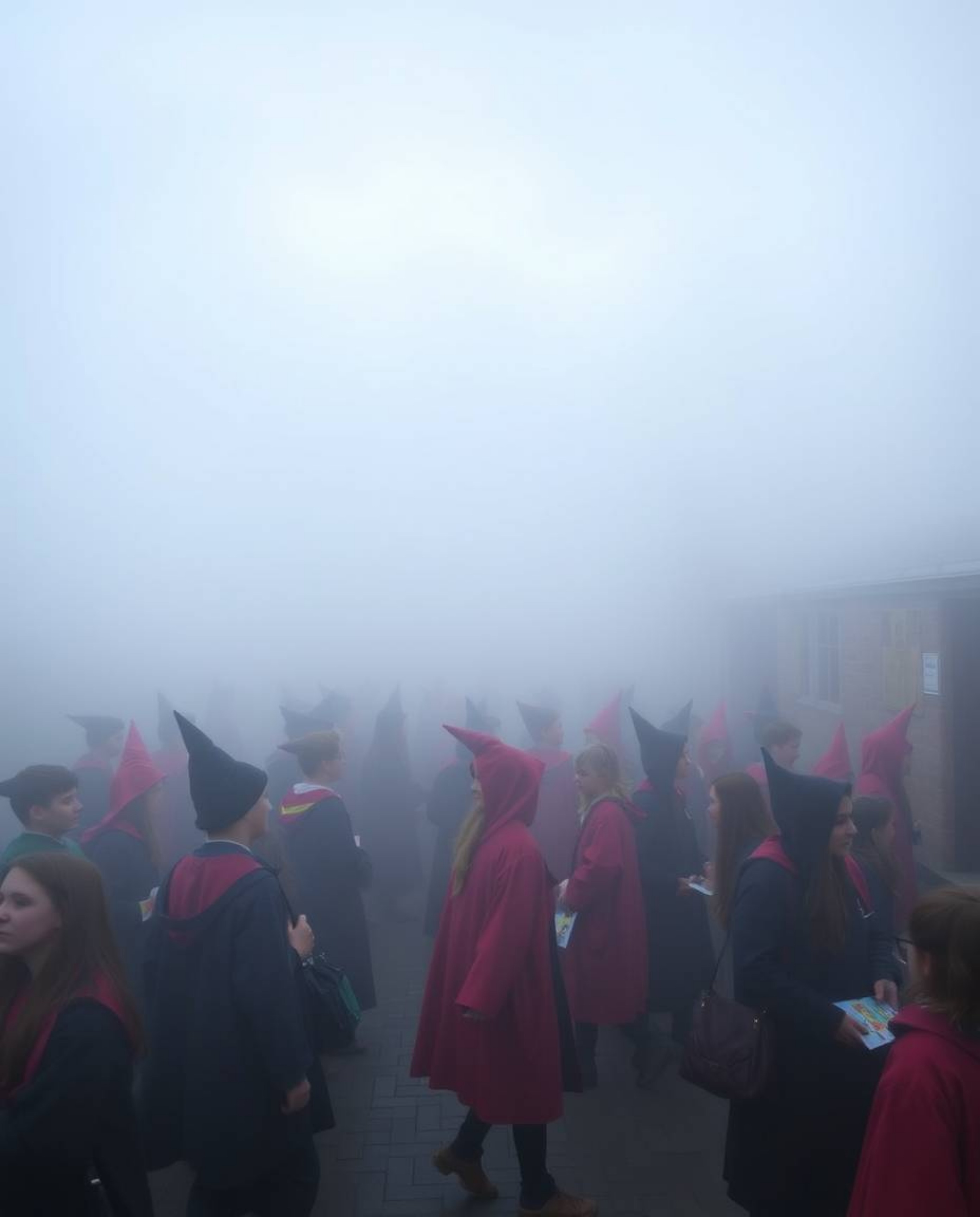 Step into a world of enchantment where a magical school, teeming with young wizards, is shrouded in a thick fog, creating an