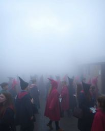 Step into a world of enchantment where a magical school, teeming with young wizards, is shrouded in a thick fog, creating an