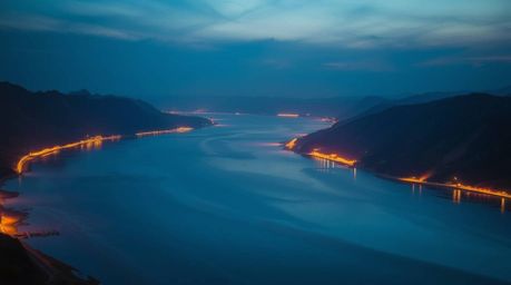A stunning photograph captures a river delta at twilight, radiating with electric and vivid colors. The scene is bathed in a 