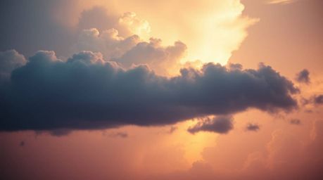 A captivating close-up reveals the delicate beauty of thunderstorm clouds illuminated by the soft pastel hues of a setting su