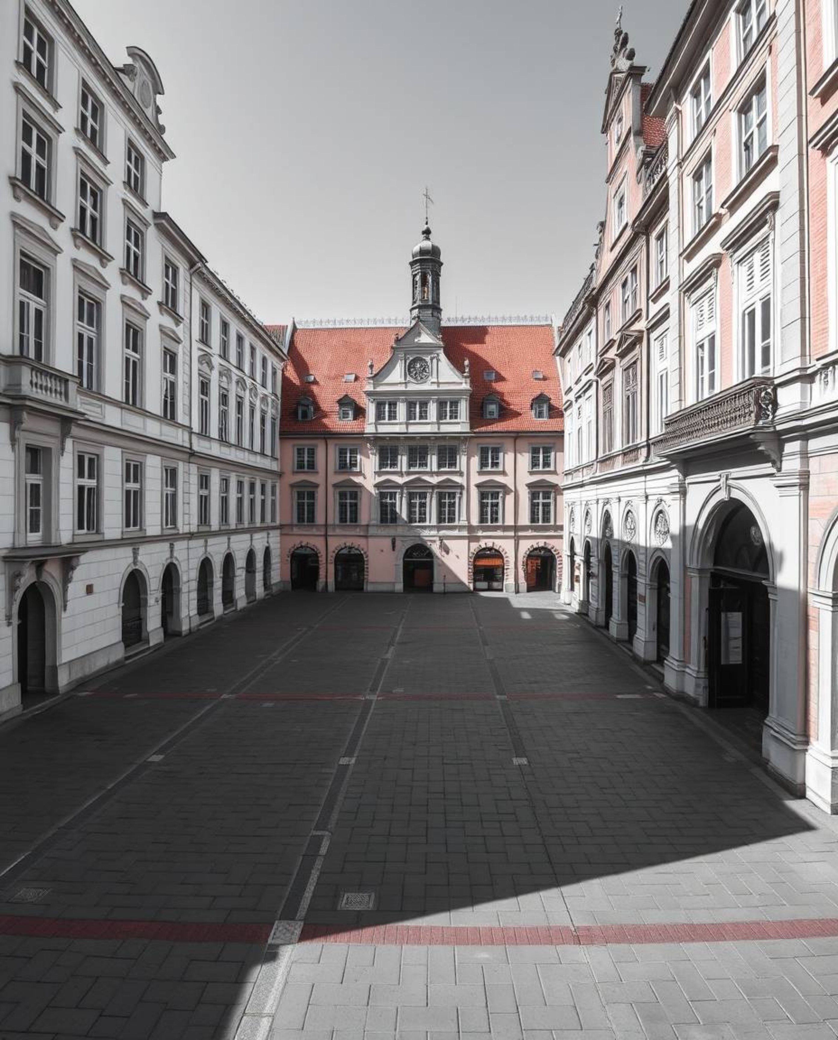 A precise architectural color photograph capturing an empty town square characterized by sharp lines, detailed structures, an