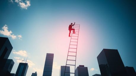 A dramatic, high-contrast image depicts a businessperson ascending a transparent ladder that disappears into a vibrant blue s
