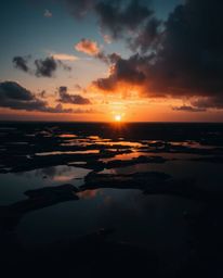 A sunset sky mirrored in tidal pools is depicted in a dramatic cinematic style. This artwork is characterized by harsh lighti
