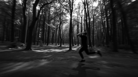 Experience a thrilling black and white chase scene set within a looping forest backdrop.  High contrast and low-key lighting 