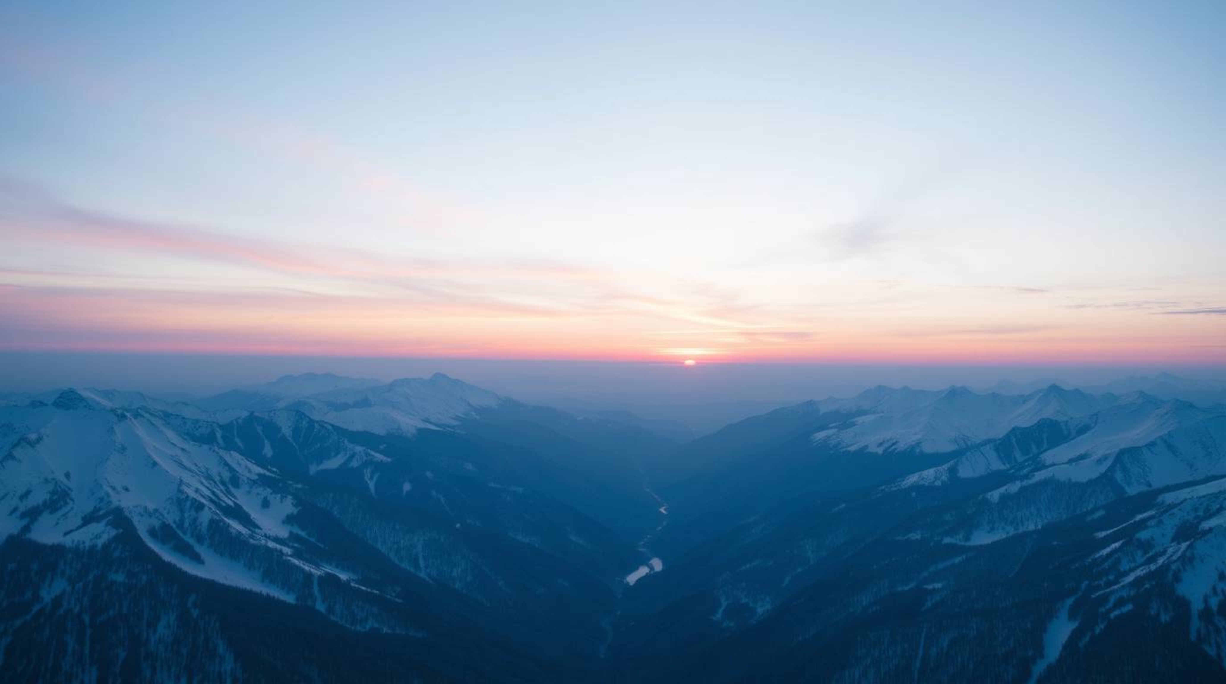 Capture the serene beauty of snow-covered mountains bathed in the soft hues of a pastel sunset.  This high-angle perspective 