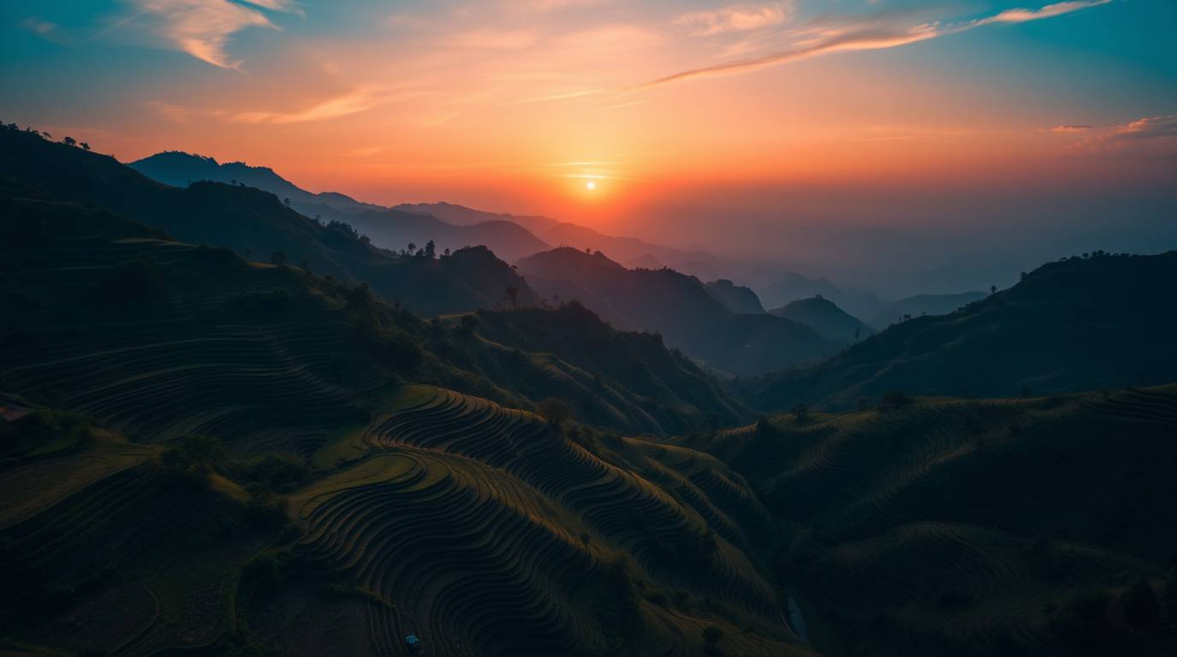 Capture the breathtaking beauty of a sunset over mountainous rice terraces with this high-resolution stock photo. Featuring a
