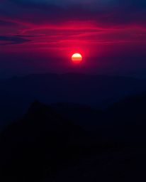 Immerse yourself in a mystic and enchanting scene of a sunset viewed from a high alpine peak. This artwork is rendered in a s