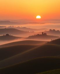 Fine art photograph: Tuscan sunset over misty rolling hills, warm golden glow, soft contrast, soft saturation, radiant and lu