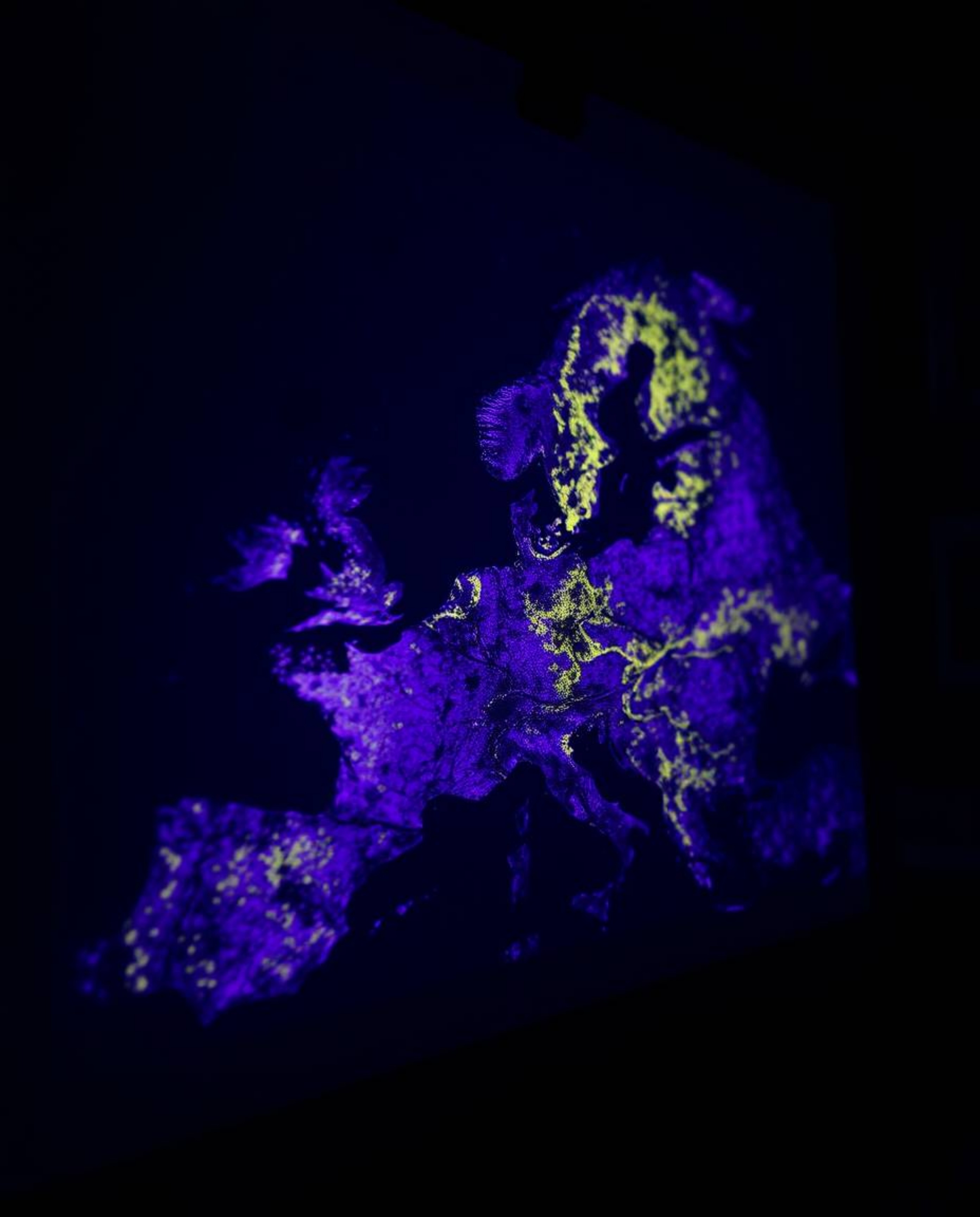 Explore a captivating deep ultraviolet glowing map projection in an old study, captured in a tight close-up shot. Vivid purpl