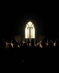 A captivating image of a magical school teeming with young wizards, silhouetted against a stark black background. Intense bac