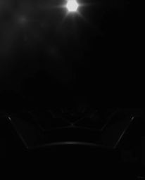 This black and white image showcases an intense, dramatic lighting and a warm golden glow, highlighting a captivating geometr