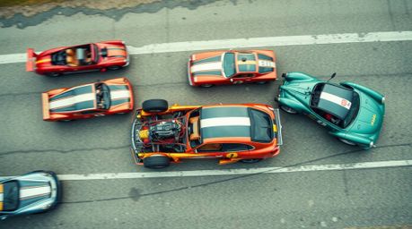 A stunning, professional overhead photograph captures a chaotic and exhilarating wacky racing scene featuring outlandish cars