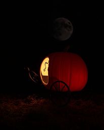 A surreal infrared photograph captures the magical transformation of a pumpkin into a carriage. The high-contrast image, rend