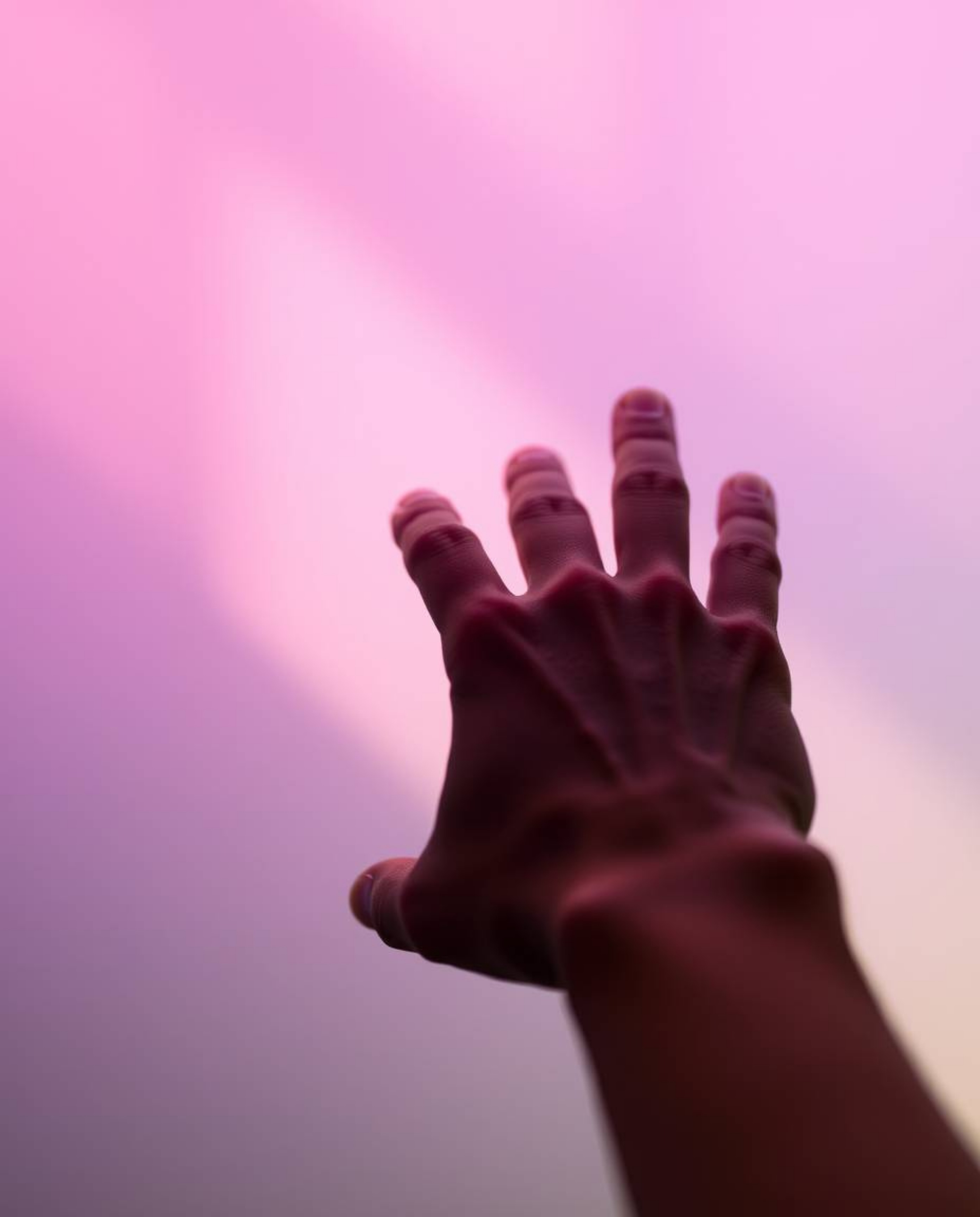 This artwork features a smooth gradient close-up of a hand reaching for light, transitioning seamlessly from darkness. It evo
