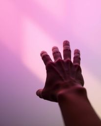 This artwork features a smooth gradient close-up of a hand reaching for light, transitioning seamlessly from darkness. It evo