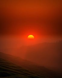 Volumetric lighting illuminates a sunset over terraced tea plantations, with dramatic light beams piercing through dust or fo