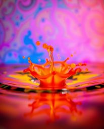 Explore the mesmerizing world of ink in water with this captivating macro photography. Witness vibrant and electric colors ex