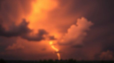 Capture the dramatic beauty of a thunderstorm illuminated by the setting sun with a mesmerizing blurred bokeh effect. This im