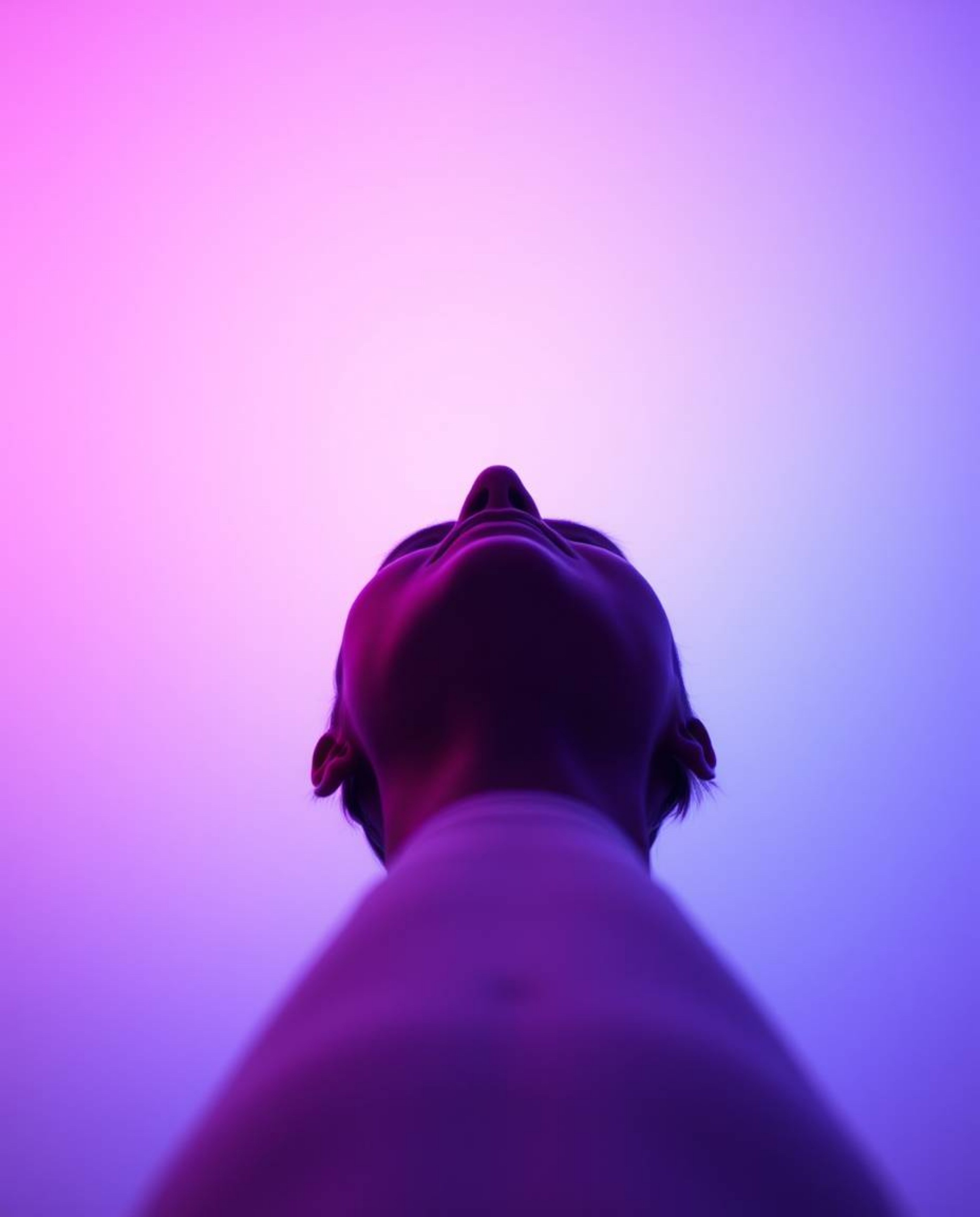 A captivating low-angle shot showcases a soft gradient blending pink, blue, and violet hues against a minimal backdrop.  The 
