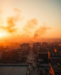 A dramatic fine art photograph capturing a city engulfed in flames during the warm golden hour.  The high-angle, elevated vie