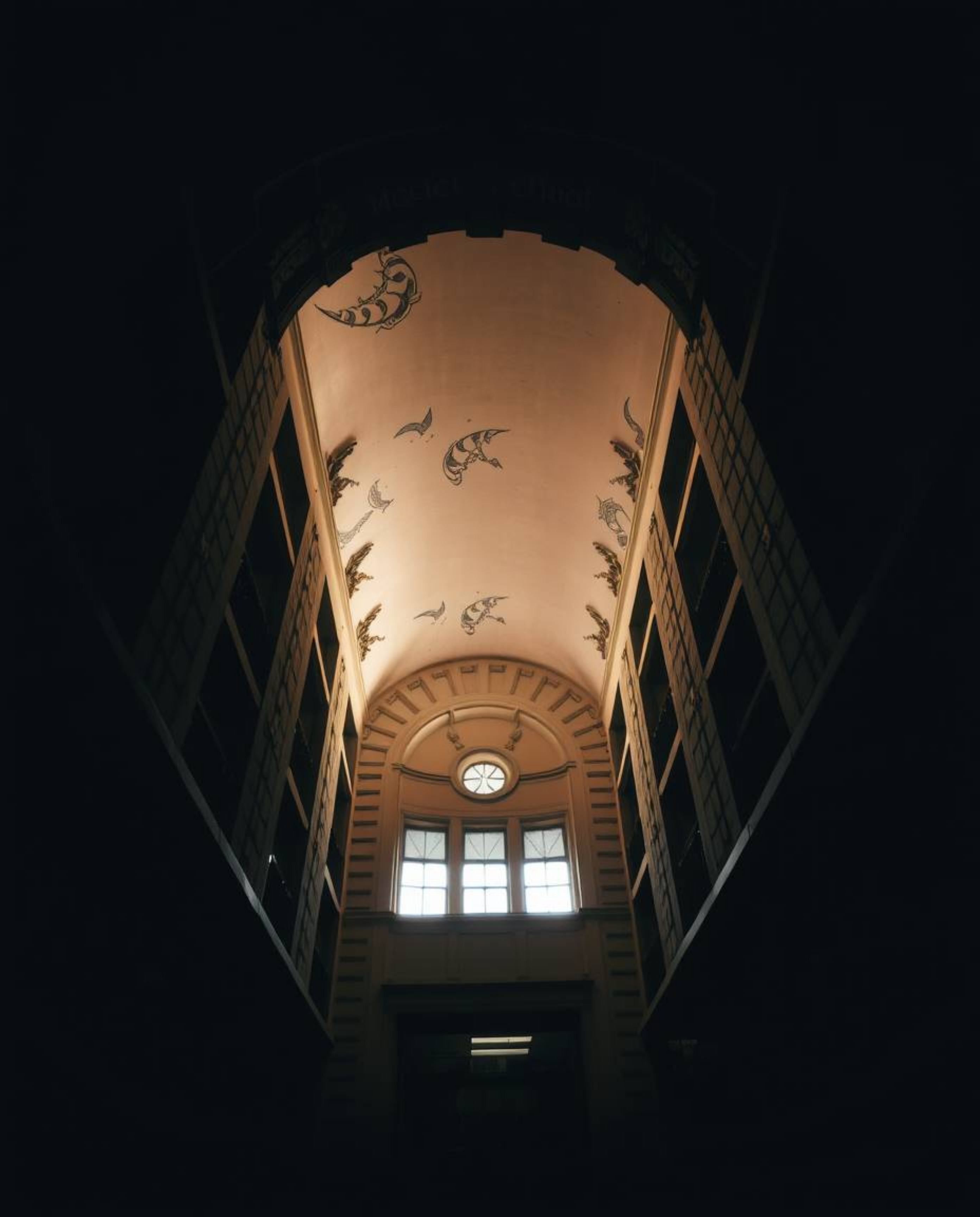 Discover a captivating low-angle perspective of a magical school, bathed in dramatic chiaroscuro lighting.  The image feature