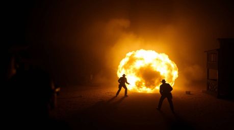 A dramatic high-angle silhouette of a classic exploding TNT gag in the Wild West, showcasing a powerful contrast between ligh
