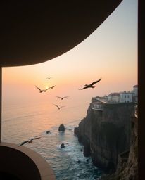 This architectural photograph captures a stunning coastal cliff sunset, complete with soaring birds that add a dynamic elemen