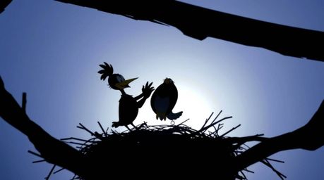 A charming scene featuring two cartoon birds diligently building their nest, rendered in a classic animation style with a hig