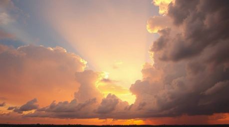 A stunning high-angle shot captures the dramatic beauty of thunderstorm clouds illuminated by the warm, golden light of sunse