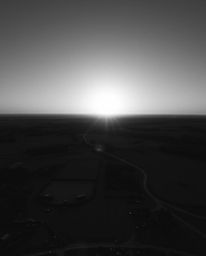This captivating image showcases a classic black and white high-angle view of a sunrise illuminating a war-torn landscape. Th