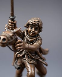 This antique cast bronze sculpture captures a brave, Disney-style hero amidst a thrilling desert adventure. The detailed focu