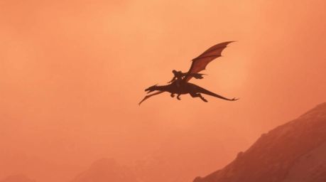 A breathtaking cinematic scene depicts a dragon and its rider soaring above majestic icy mountains.  The soft-focus shot, bat