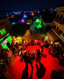 Experience a captivating musical performance in a brightly lit town square, awash in bioluminescent colors.  Natural light en