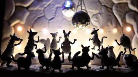 This sculptural clay art piece captures the energy of an animal dance party illuminated by dazzling disco lights.  The artwor