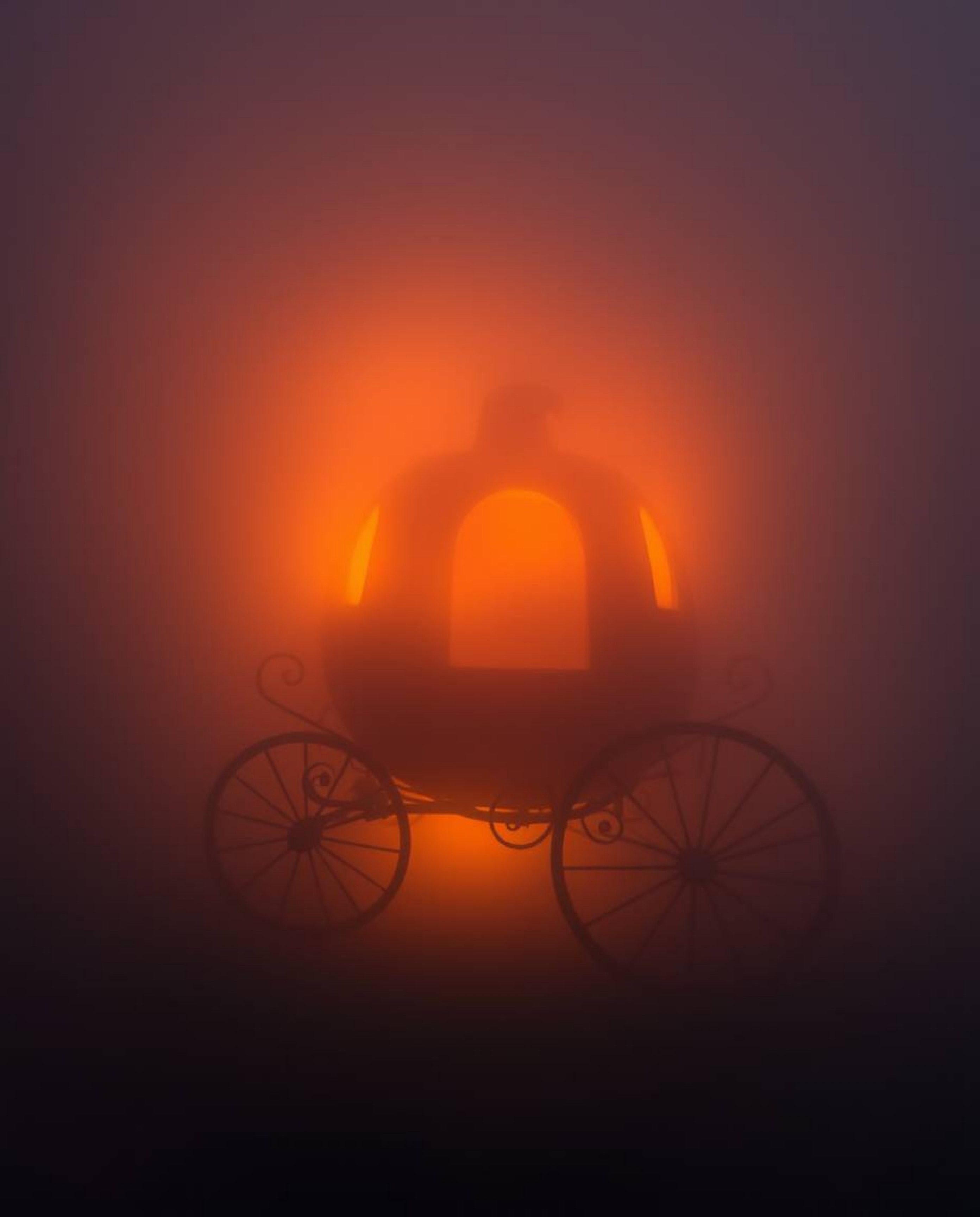 Experience the enchantment of a magical pumpkin transforming into a magnificent carriage, shrouded in a thick, mysterious fog
