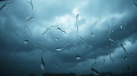 Experience the intensity of dramatic weather captured through a high-angle perspective of a glass object, reflecting smooth g