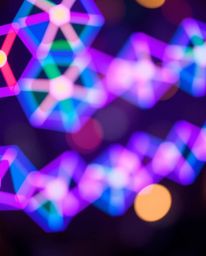 This captivating light art piece showcases a seamless geometric pattern comprised of hexagons and triangles, rendered in a vi