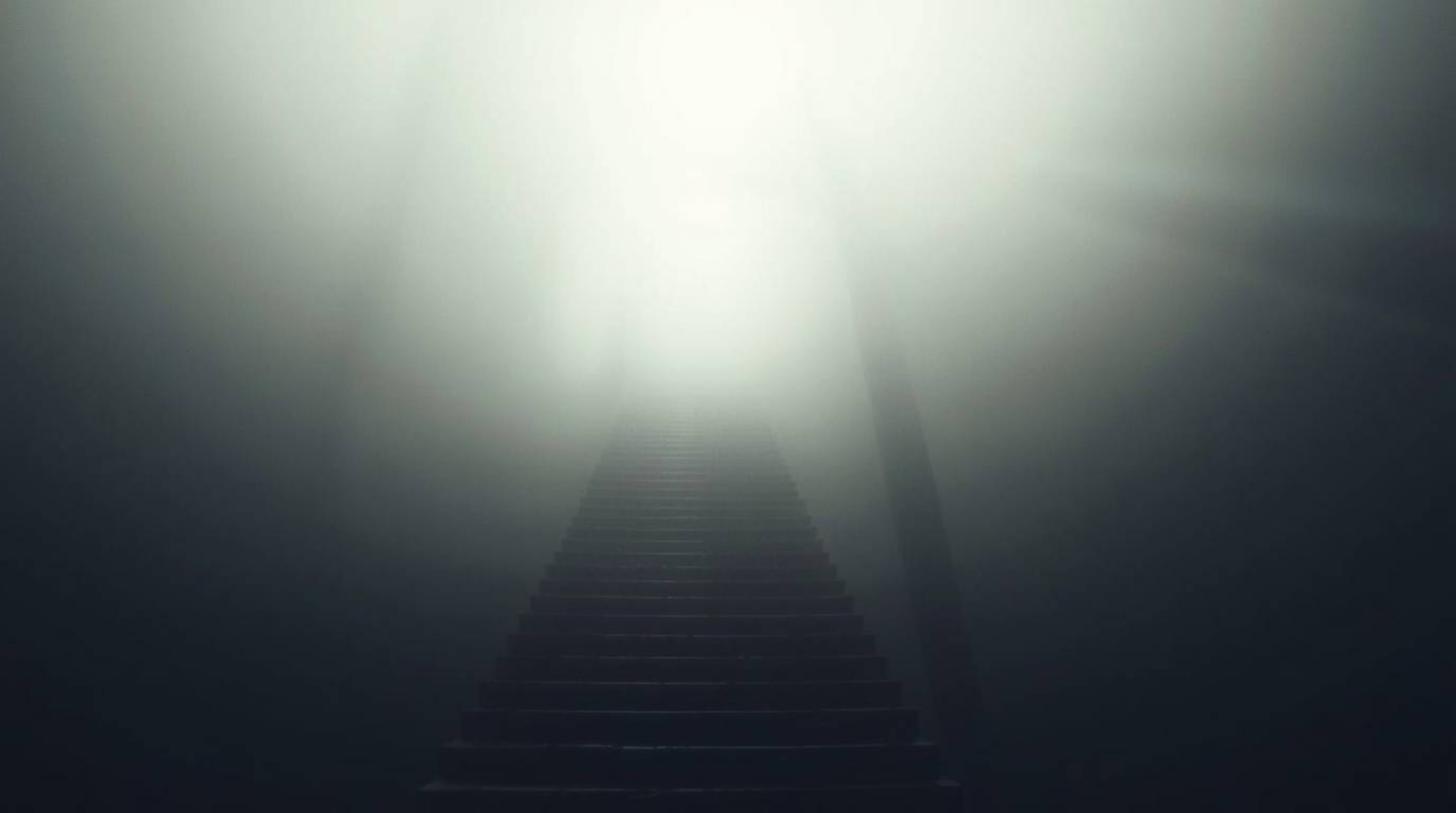 A surreal stairway image evokes a powerful sense of spiritual awakening.  Ascending through thick fog towards a celestial lig
