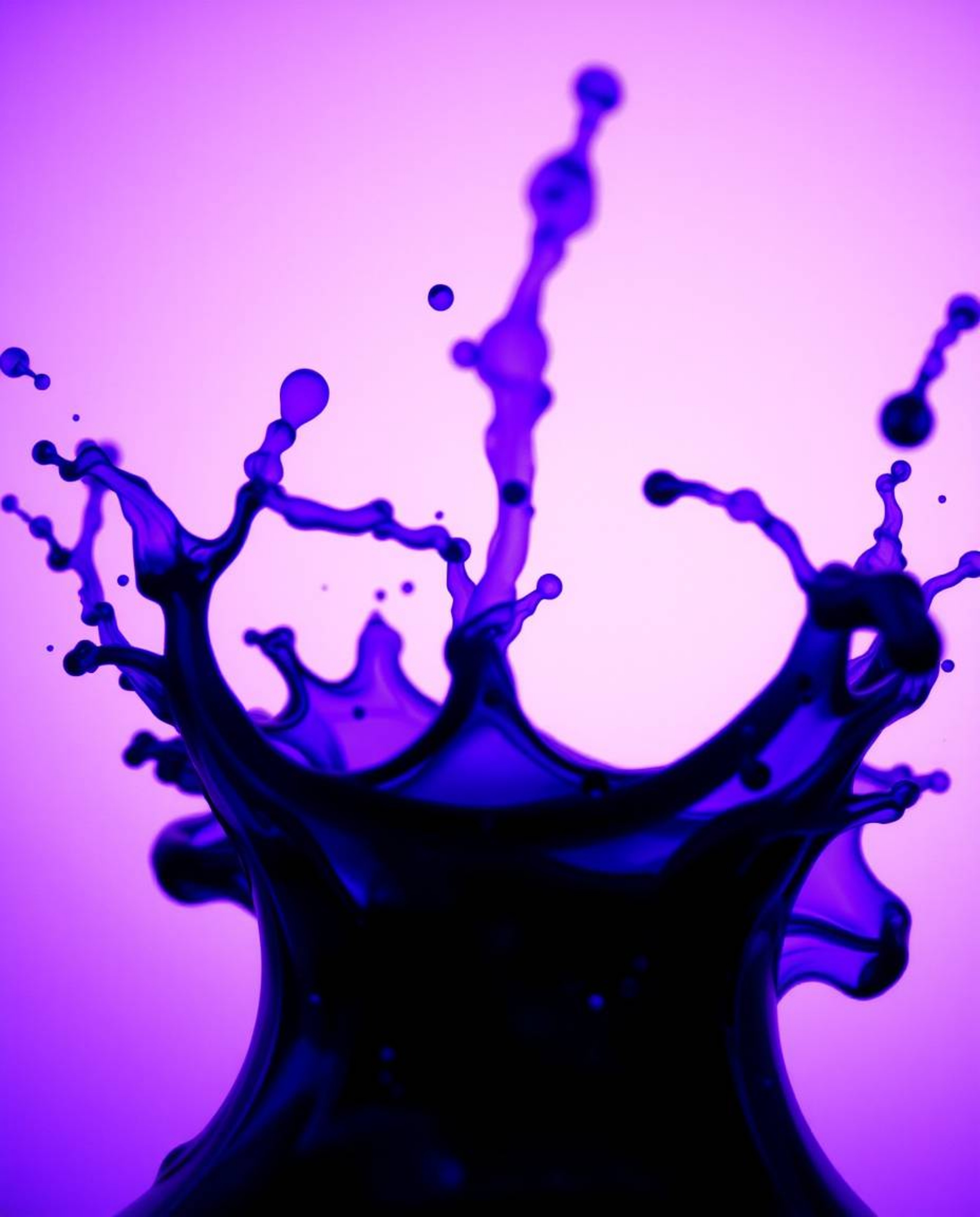Explore the captivating world of ink in water through macro photography, showcasing deep ultraviolet hues and low-angle persp