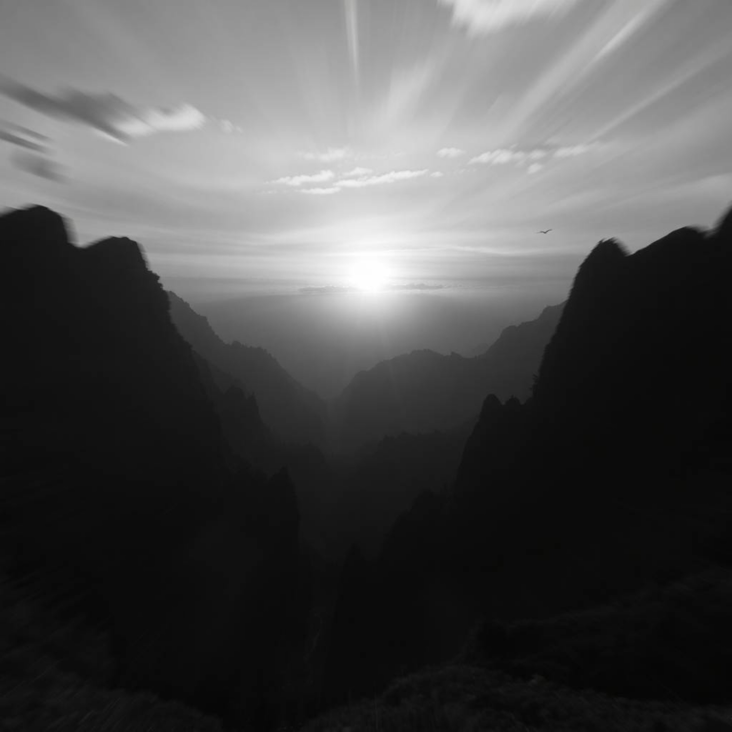 Experience a dreamlike journey into a surreal black and white photograph capturing a dynamic and moving sunset over a quiet m